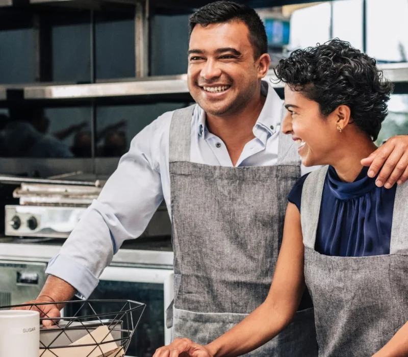 happy-small-business-owners-at-their-cafe