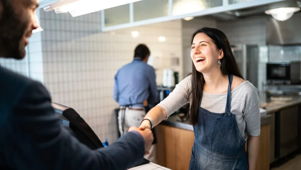 Barista Shaking Hands With Customer 1024x577