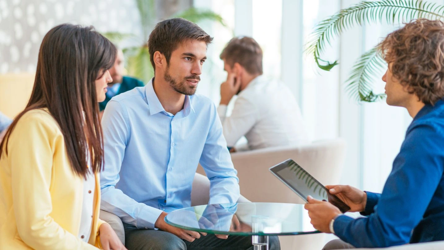 Concerned Couple Discussing Loan Rates With Personal Banker