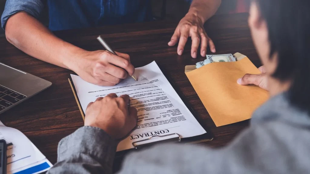 Contract Cash Loans Concept Man Signs A Loan Agreement With A Loan Officer 1024x577