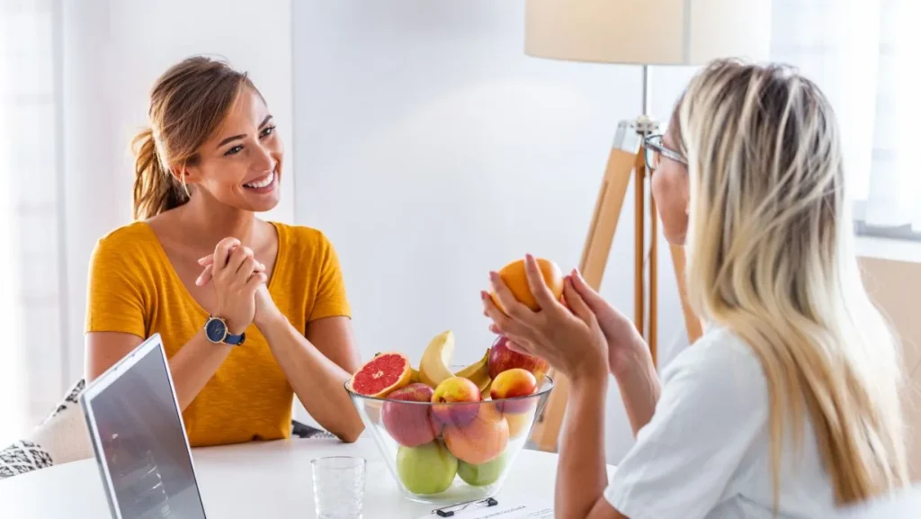 female nutritionist giving consultation to patient making diet plan