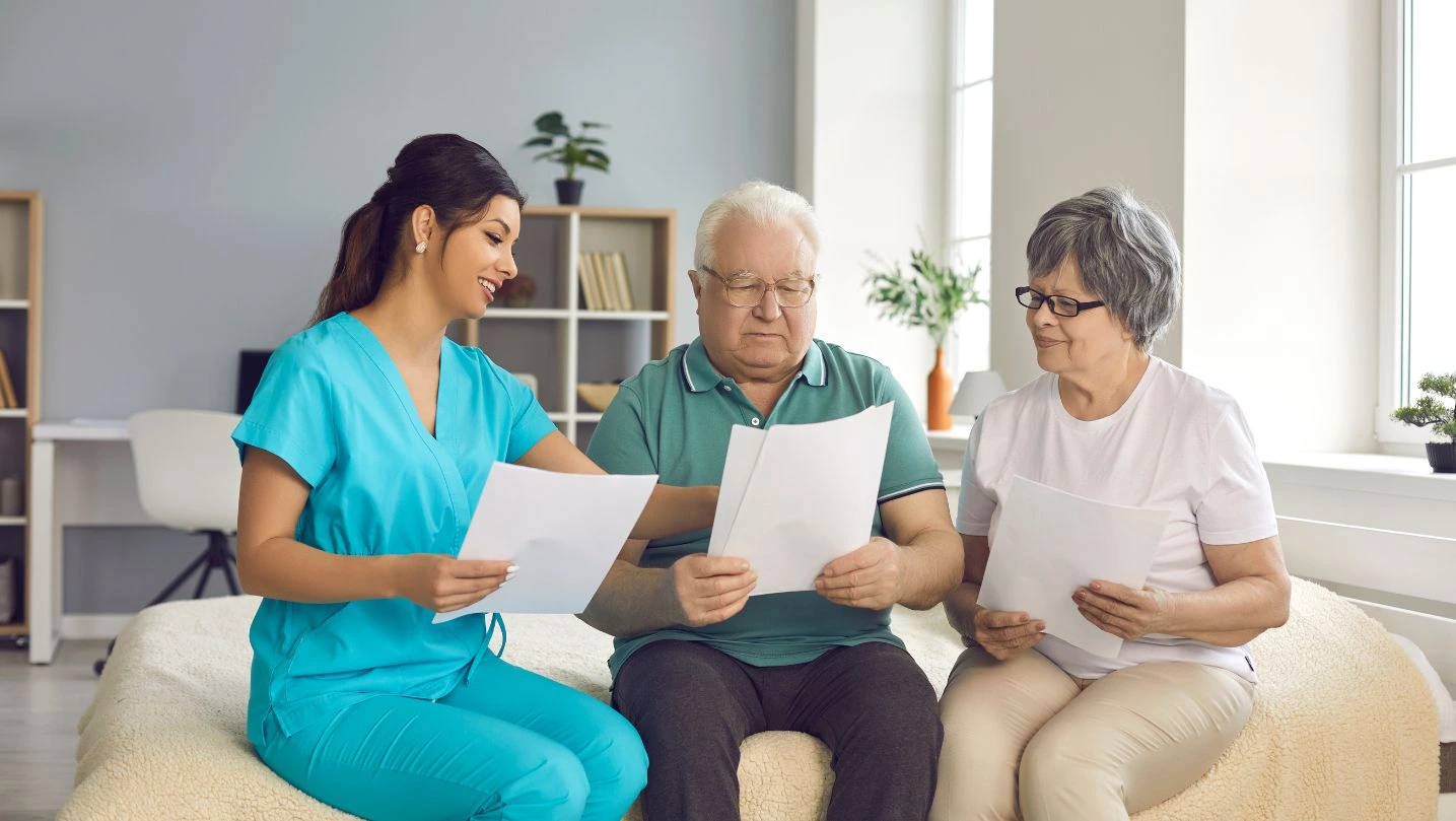 Home Care Nurse Helps Senior Patients Understand And Fill Out Homecare Service Contract