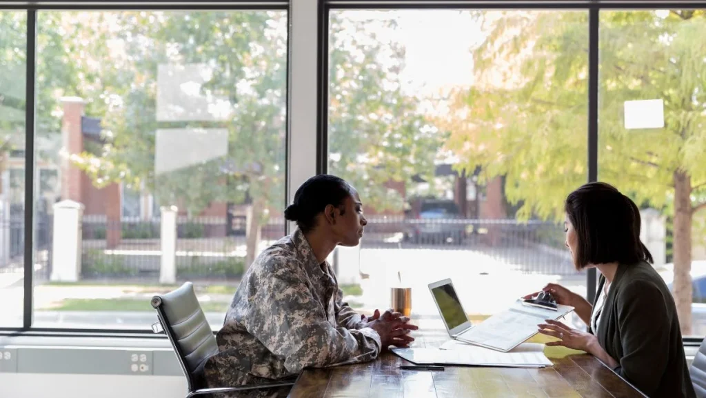 Loan Officer Reviews Loan Application With Veteran 1024x577