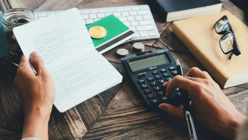 Op View Of Person Using Calculator 1024x577