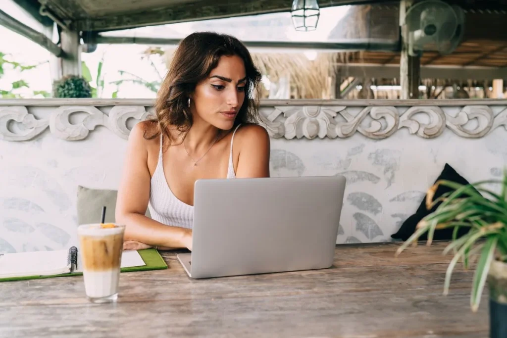 Self Employed Female Working On Laptop In Summer Cafe 1024x683