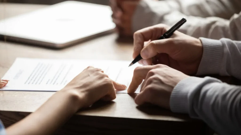 Solicitor Pointing At Contract Showing Client Where To Write Signature 1024x577