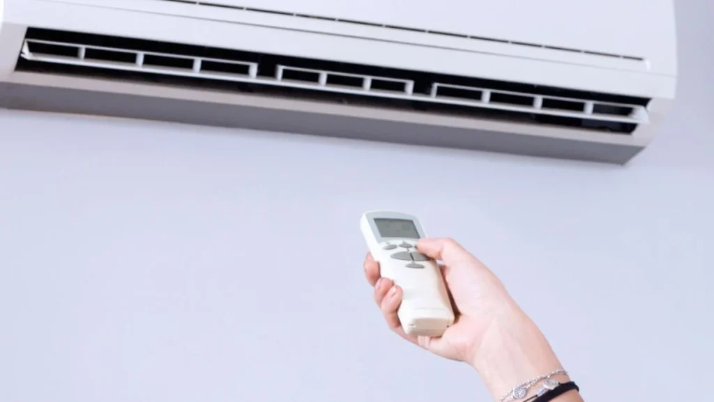 Woman Using Remote Control Of Aircondition 1024x577