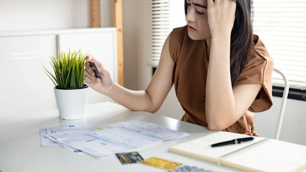 Young Asian Woman Is Stressed And Overthink By Debt From Many Credit Cards And Bills 1024x577